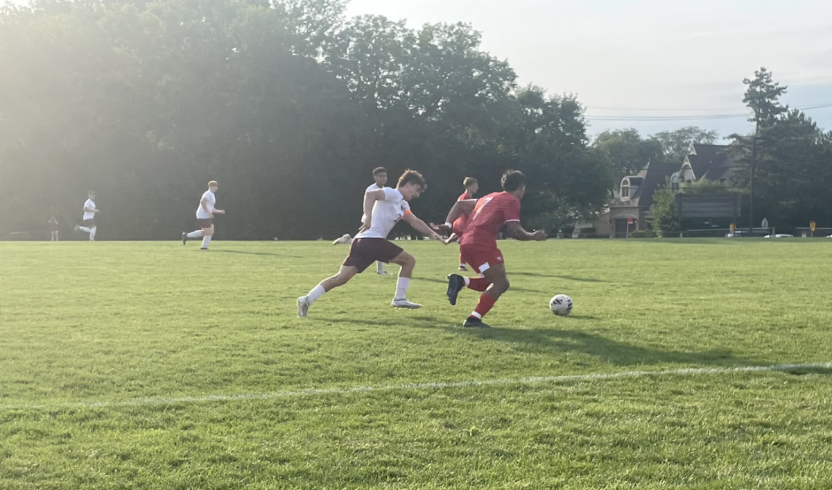 Enzo Cinque, senior, battles for possession during the Sept. 5 game against Brother Rice. 
